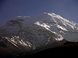 Ecuador Chimborazo 05-03 Estrella del Chimborazo Ventimilla and Whymper Summits At Sunrise Here�s a view of the rock band and the glaciers of the Ventimilla (6267m) summit and the main Whymper (6310m) summit of Chimborazo after sunrise viewed from the Estrella del Chimborazo.